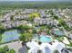Overhead image featuring community pool, tennis courts, clubhouse and grounds surrounded by lush landscaping at 8118 Fan Palm Way, Kissimmee, FL 34747