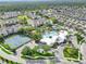 Aerial shot of community pool, tennis courts, clubhouse and manicured grounds in a beautiful neighborhood at 8118 Fan Palm Way, Kissimmee, FL 34747