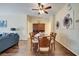Elegant dining room with a glass-top table, seating for six, and stylish decor at 8118 Fan Palm Way, Kissimmee, FL 34747