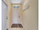 Bright foyer featuring tile flooring, coat hooks, and a clear view of the living spaces, creating an airy entrance at 8118 Fan Palm Way, Kissimmee, FL 34747
