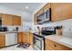 Well-equipped kitchen featuring stainless steel appliances, functional cabinets, and bright, easy-to-clean tile flooring at 8118 Fan Palm Way, Kissimmee, FL 34747