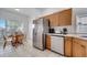 Efficient kitchen with stainless steel refrigerator, cozy breakfast nook, and practical dishwasher creating a modern dining space at 8118 Fan Palm Way, Kissimmee, FL 34747