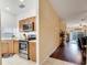 Open kitchen view showcasing stainless steel appliances, warm wood cabinets, and a seamless transition to the living area at 8118 Fan Palm Way, Kissimmee, FL 34747