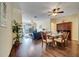 Open-concept living and dining area with hardwood floors and modern furnishings at 8118 Fan Palm Way, Kissimmee, FL 34747