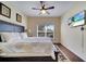 Bedroom with wood floors, a large bed, a ceiling fan, and a TV at 8118 Fan Palm Way, Kissimmee, FL 34747