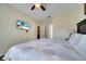 Bright bedroom with a bed, and a wall-mounted TV at 8118 Fan Palm Way, Kissimmee, FL 34747
