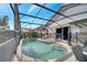 Sparkling pool with a screened enclosure, patio, and landscaped surroundings at 8118 Fan Palm Way, Kissimmee, FL 34747