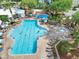 Aerial view of resort-style pool, tanning chairs, and splashpad at 8118 Fan Palm Way, Kissimmee, FL 34747