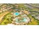 Expansive community pool area featuring a lazy river, lush landscaping, and ample seating at 9044 Azalea Sands Ln # 4011, Davenport, FL 33896
