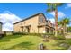 Charming two-story home with a landscaped yard and lush green grass at 9044 Azalea Sands Ln # 4011, Davenport, FL 33896