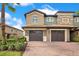 Charming multi-story home featuring a two-car garage and well-manicured landscaping with an inviting brick driveway at 9044 Azalea Sands Ln # 4011, Davenport, FL 33896