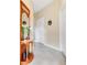 Inviting hallway with neutral walls, tiled floors, and a charming wooden hall tree with ornate mirror and coat hooks at 9044 Azalea Sands Ln # 4011, Davenport, FL 33896