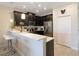 Bright kitchen boasts sleek stainless steel appliances, quartz countertops, and stylish breakfast bar with seating at 9044 Azalea Sands Ln # 4011, Davenport, FL 33896