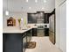 Modern kitchen featuring stainless steel appliances, quartz countertops, dark cabinets, and tiled floor at 9044 Azalea Sands Ln # 4011, Davenport, FL 33896