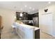 Bright kitchen boasts sleek stainless steel appliances, quartz countertops, and stylish breakfast bar with seating at 9044 Azalea Sands Ln # 4011, Davenport, FL 33896
