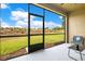 Screened patio with expansive backyard views of landscaped community with a ceiling fan and relaxing atmosphere at 9044 Azalea Sands Ln # 4011, Davenport, FL 33896