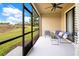 Enclosed patio featuring a ceiling fan and comfortable seating with scenic views of landscaped community outdoors at 9044 Azalea Sands Ln # 4011, Davenport, FL 33896