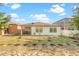 Backyard featuring a screen-enclosed patio, newly planted foliage, and a grassy area at 9188 Chandler Dr, Groveland, FL 34736