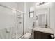 A bright bathroom features a walk-in shower, vanity with storage, and a mirror at 9188 Chandler Dr, Groveland, FL 34736