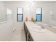 Well-lit bathroom with double sinks, a large mirror and a sleek design that offer both style and functionality at 9188 Chandler Dr, Groveland, FL 34736