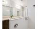 Bright bathroom featuring double sinks, a shower with glass and a sleek design that offer both style and functionality at 9188 Chandler Dr, Groveland, FL 34736