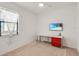 A bright bedroom is staged with a desk, red drawers, and a wall-mounted television at 9188 Chandler Dr, Groveland, FL 34736
