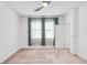Bright bedroom featuring a ceiling fan, neutral tones and big windows that add an airy and relaxing feel at 9188 Chandler Dr, Groveland, FL 34736