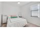 A bright bedroom features white furniture, a bed, and a window with natural light at 9188 Chandler Dr, Groveland, FL 34736