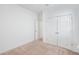 A simply decorated bedroom features double doors and neutral carpeting at 9188 Chandler Dr, Groveland, FL 34736