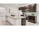 Well-appointed kitchen with dark wood cabinets, stainless steel appliances, granite countertops, and an inviting atmosphere at 9188 Chandler Dr, Groveland, FL 34736