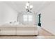 Bright living room featuring a modern chandelier, plush seating and neutral tones for a cozy yet stylish space at 9188 Chandler Dr, Groveland, FL 34736