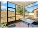 A sunroom features brick flooring, large screens, and a table for outdoor enjoyment at 9188 Chandler Dr, Groveland, FL 34736