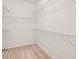 A walk-in closet features wire shelving and neutral carpeting at 9188 Chandler Dr, Groveland, FL 34736