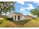 The backyard shows a well-maintained lawn, and the exterior features of the house at 9469 Edenshire Cir, Orlando, FL 32836