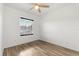Bright bedroom with wood-look flooring, a ceiling fan and natural light from a window at 9469 Edenshire Cir, Orlando, FL 32836