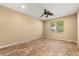 Bedroom with hardwood floors, a ceiling fan, and natural light streaming through the window at 9469 Edenshire Cir, Orlando, FL 32836
