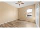 Bedroom with wood floors, a window for natural light and a closet with white doors at 9469 Edenshire Cir, Orlando, FL 32836