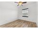 Neutral bedroom featuring wood flooring, window and a ceiling fan at 9469 Edenshire Cir, Orlando, FL 32836