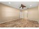 Large bedroom with wood floors, ceiling fan and two access doors to additional space at 9469 Edenshire Cir, Orlando, FL 32836