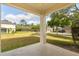 View from the porch, showcasing the spacious front yard and the surrounding neighborhood, perfect for outdoor activities at 9469 Edenshire Cir, Orlando, FL 32836