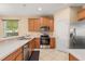 Bright kitchen featuring stainless steel appliances, light colored countertop and wooden cabinets at 9469 Edenshire Cir, Orlando, FL 32836