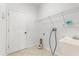 Functional laundry room with sink, shelving, and a door, designed for efficient laundry tasks at 9469 Edenshire Cir, Orlando, FL 32836