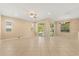 Spacious living room with tile floors, ceiling fan and natural light from the large sliding doors at 9469 Edenshire Cir, Orlando, FL 32836