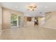 Bright and airy living room featuring tile flooring and a view of the outdoor living space at 9469 Edenshire Cir, Orlando, FL 32836