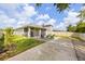 Backyard patio area features a screen, chairs and landscaped greenery at 951 Cutke Rd, St Cloud, FL 34771