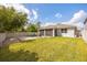 A large backyard boasts an open patio area and lush green lawn at 951 Cutke Rd, St Cloud, FL 34771