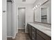 Bathroom featuring dual sinks, granite countertops, and a door to a private toilet room at 951 Cutke Rd, St Cloud, FL 34771