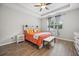 Cozy bedroom with a tray ceiling, wood-look tile floor, and a bright window view at 951 Cutke Rd, St Cloud, FL 34771