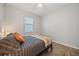 Bedroom features a comfortable bed, window, and wood-look tile floor at 951 Cutke Rd, St Cloud, FL 34771