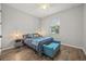 Bedroom featuring a window, ceiling fan, bench, and hardwood floors at 951 Cutke Rd, St Cloud, FL 34771